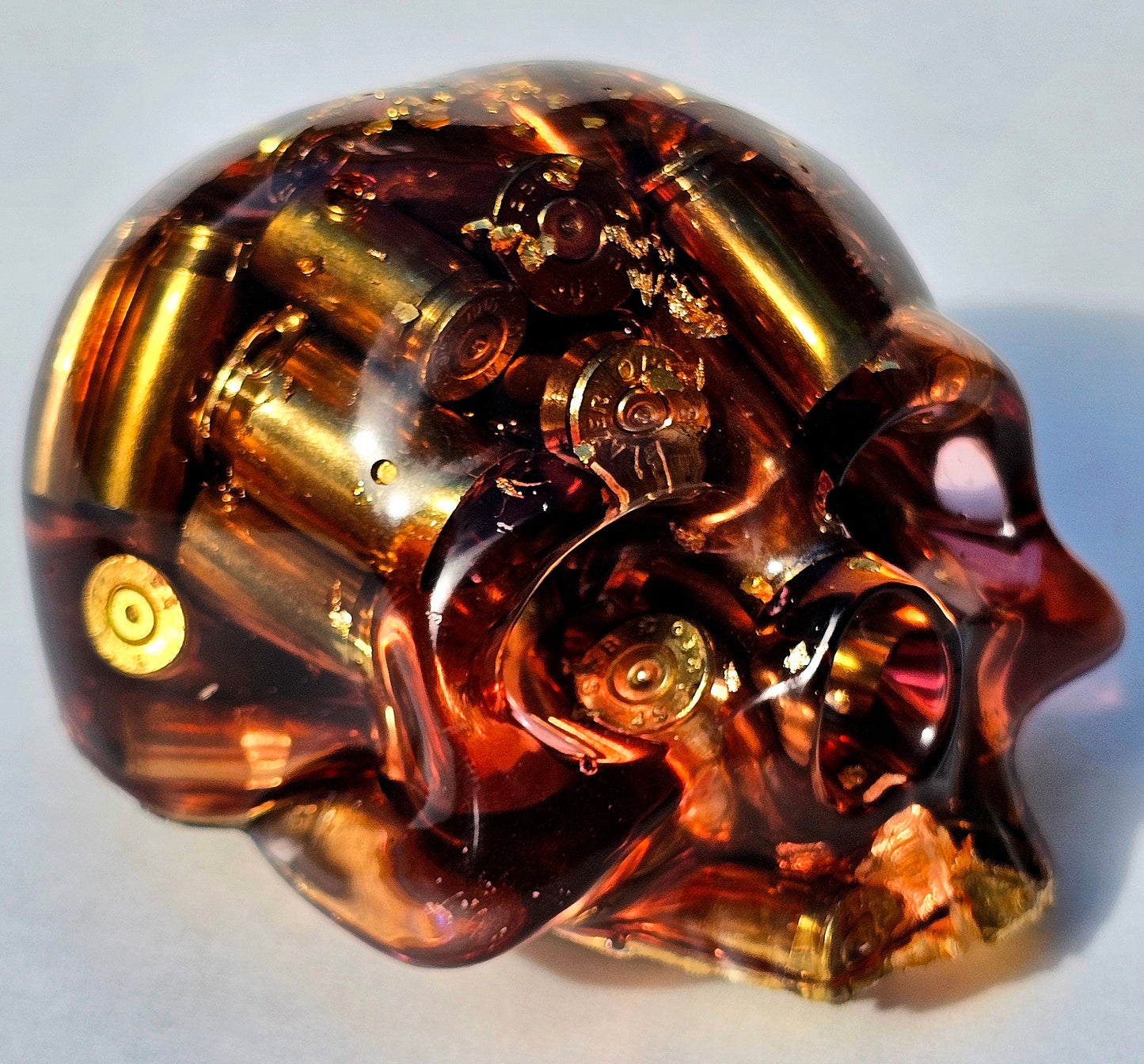 SOLD#0287 - Handmade Resin Skull - We call it the "Halfer". Fun piece, in red resin with brass hanging out the bottom. Gold accents.