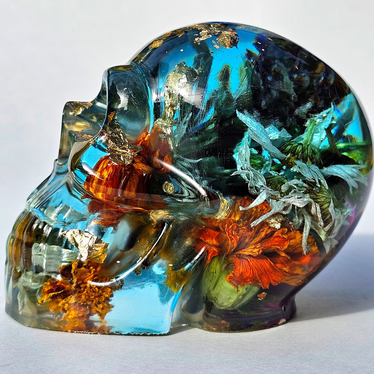#0289 - Handmade Resin Skull - This one's a bit out there!  Fun piece as well, in blue resin accompanied by mixed flowers.
