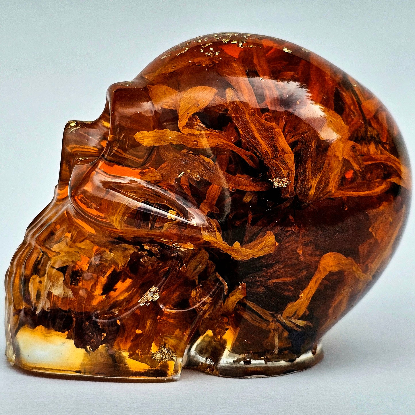 #0281 Handmade Resin Skull - Sunflowers and Marigolds in a warm orange resin.