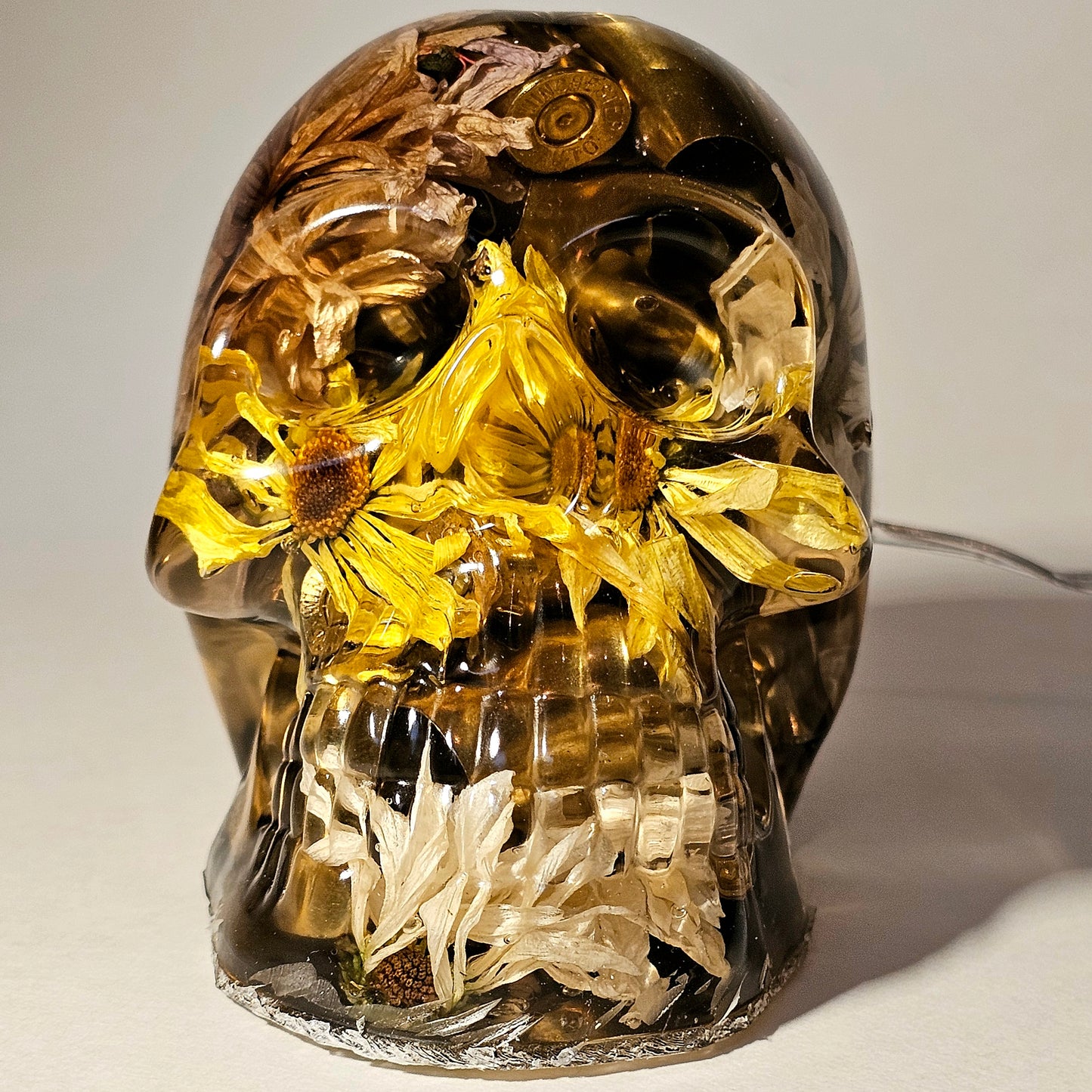 #0266 Handmade Resin Skull - Mixed flowers with brass in clear resin, very nice piece. HAS LIGHTS. Battery operated.