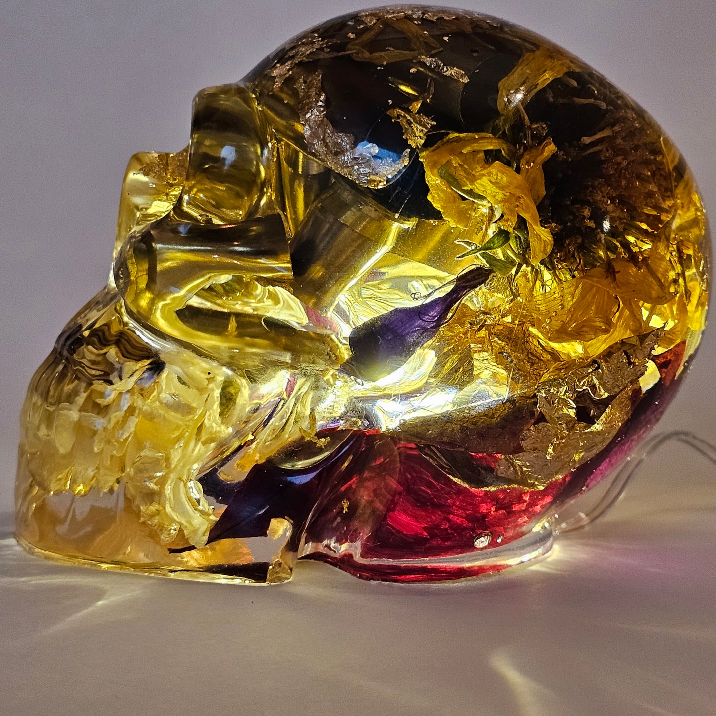 #0268 Handmade Resin Skull - Mixed flowers and brass in clear resin. HAS LIGHTS. Battery operated.