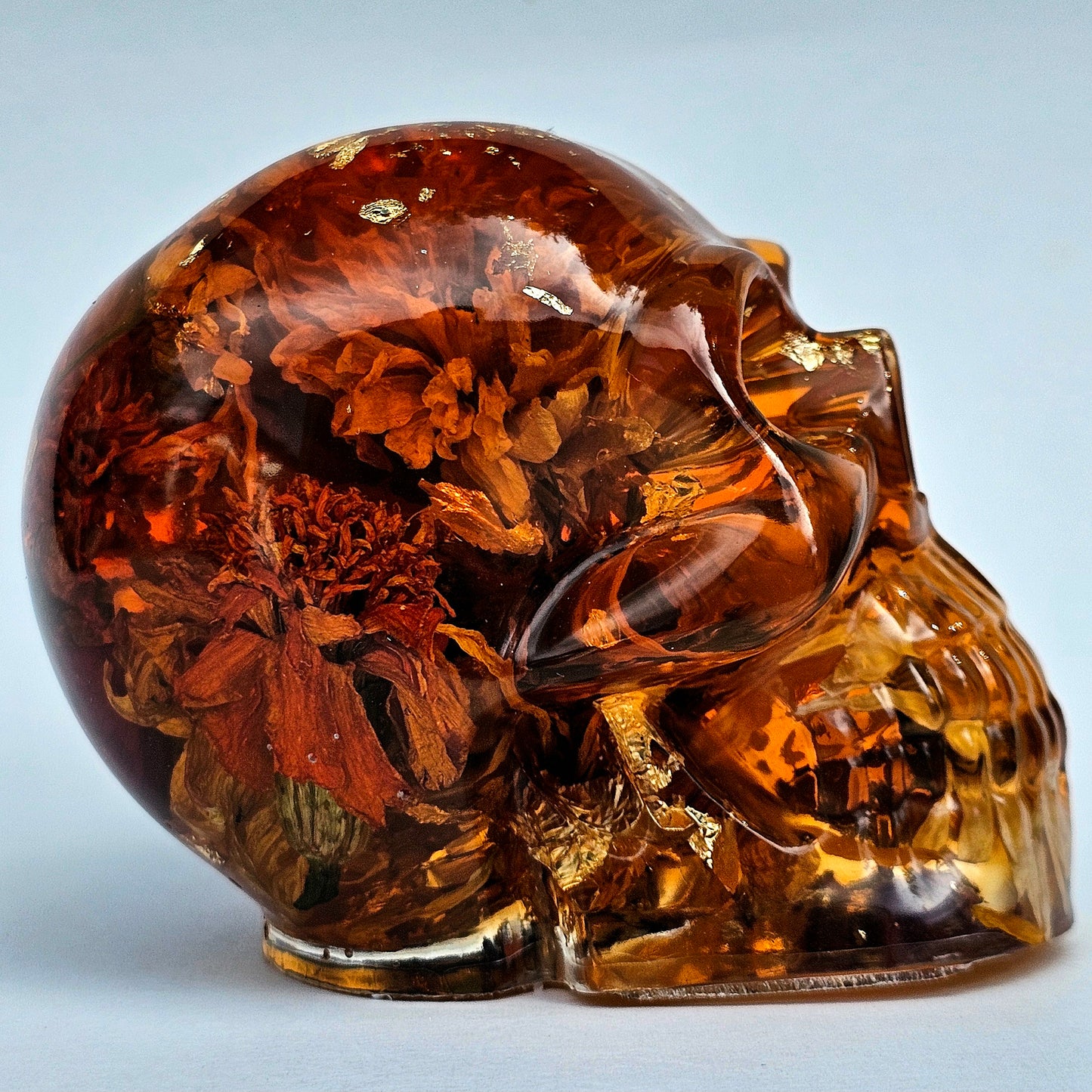 #0281 Handmade Resin Skull - Sunflowers and Marigolds in a warm orange resin.
