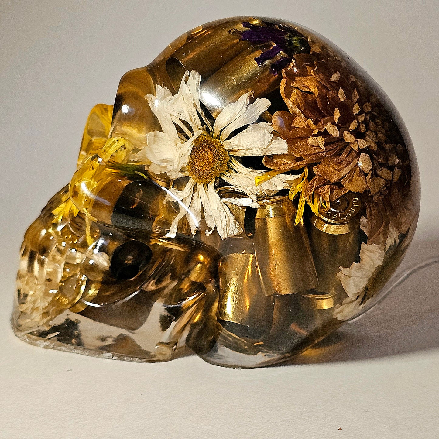 #0266 Handmade Resin Skull - Mixed flowers with brass in clear resin, very nice piece. HAS LIGHTS. Battery operated.
