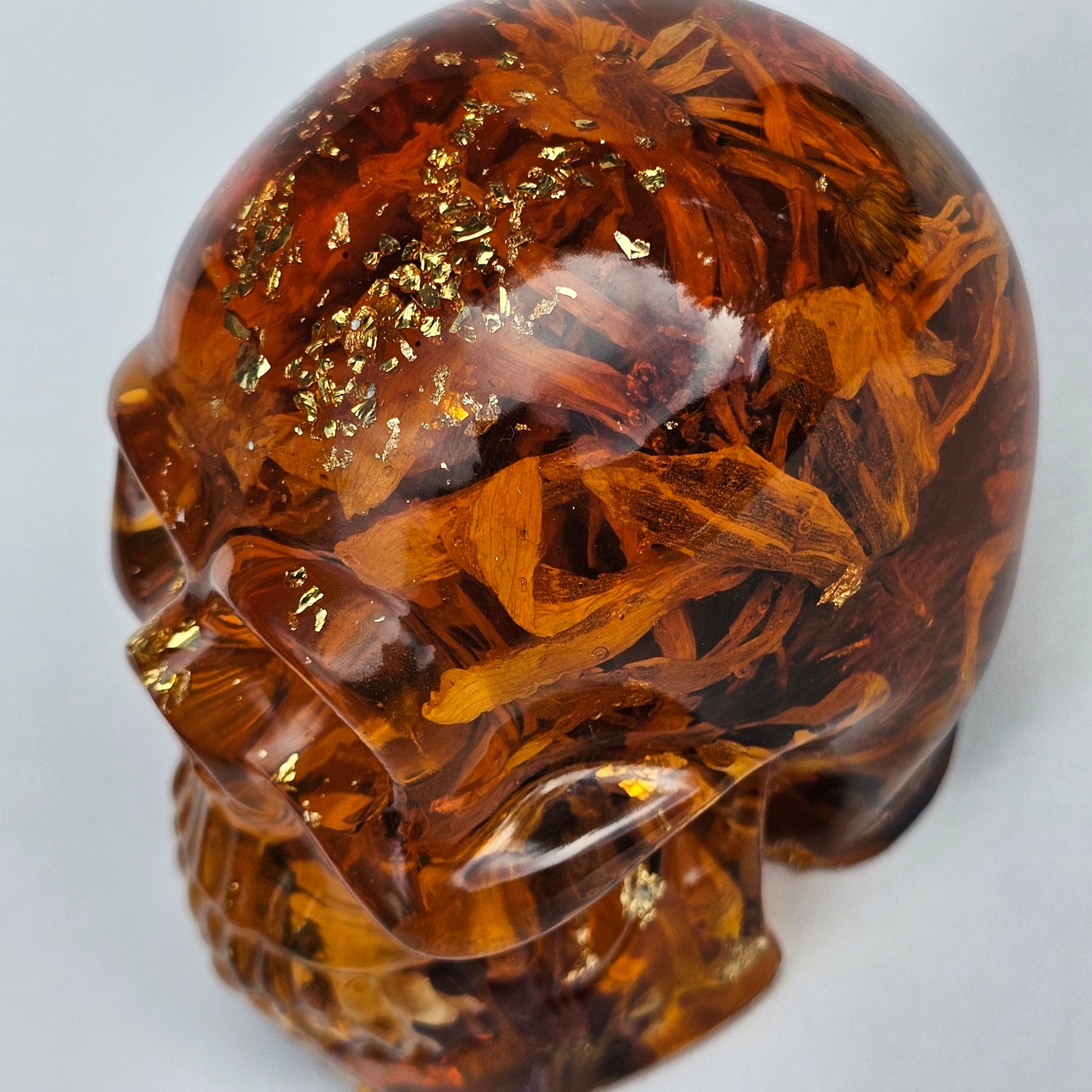 #0281 Handmade Resin Skull - Sunflowers and Marigolds in a warm orange resin.