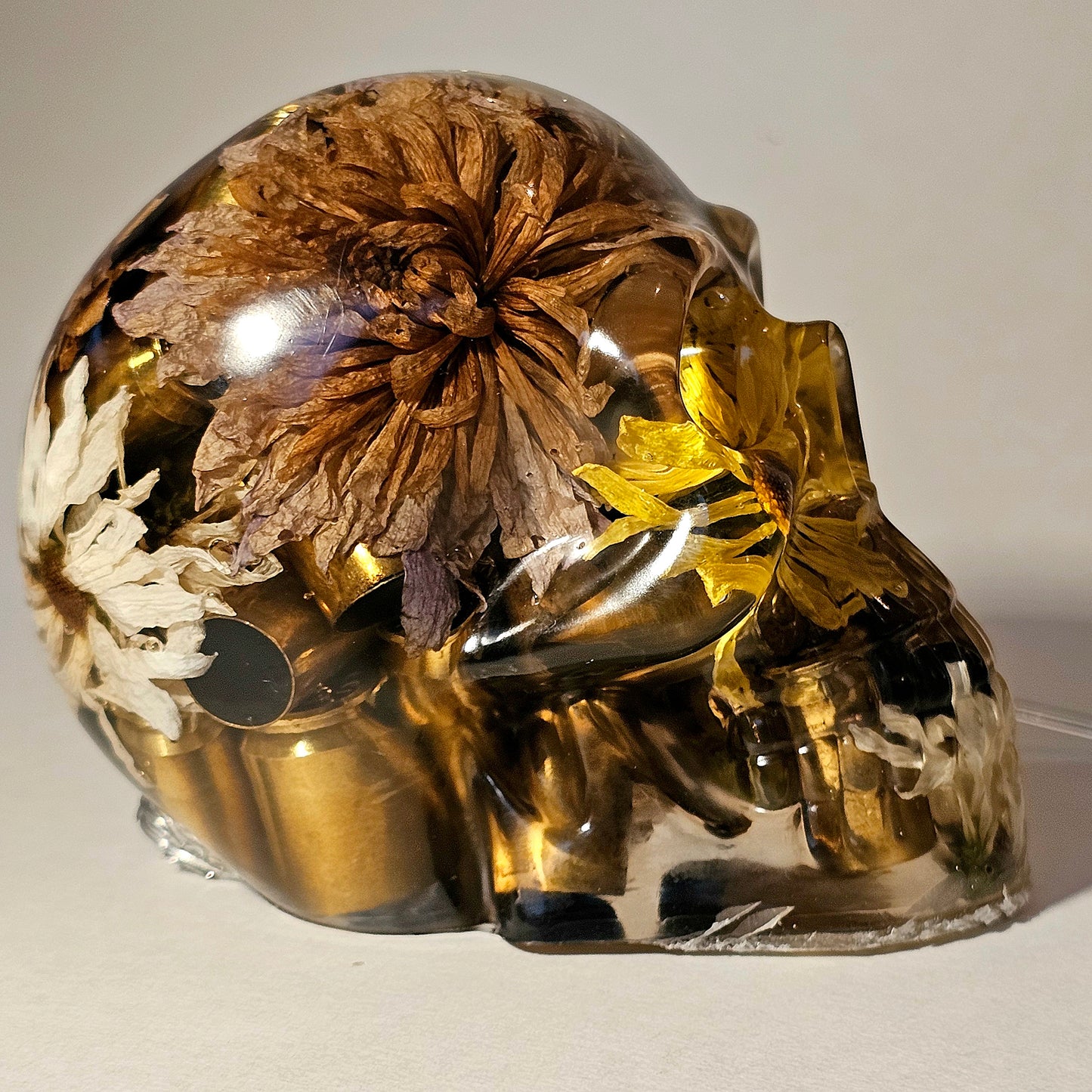 #0266 Handmade Resin Skull - Mixed flowers with brass in clear resin, very nice piece. HAS LIGHTS. Battery operated.