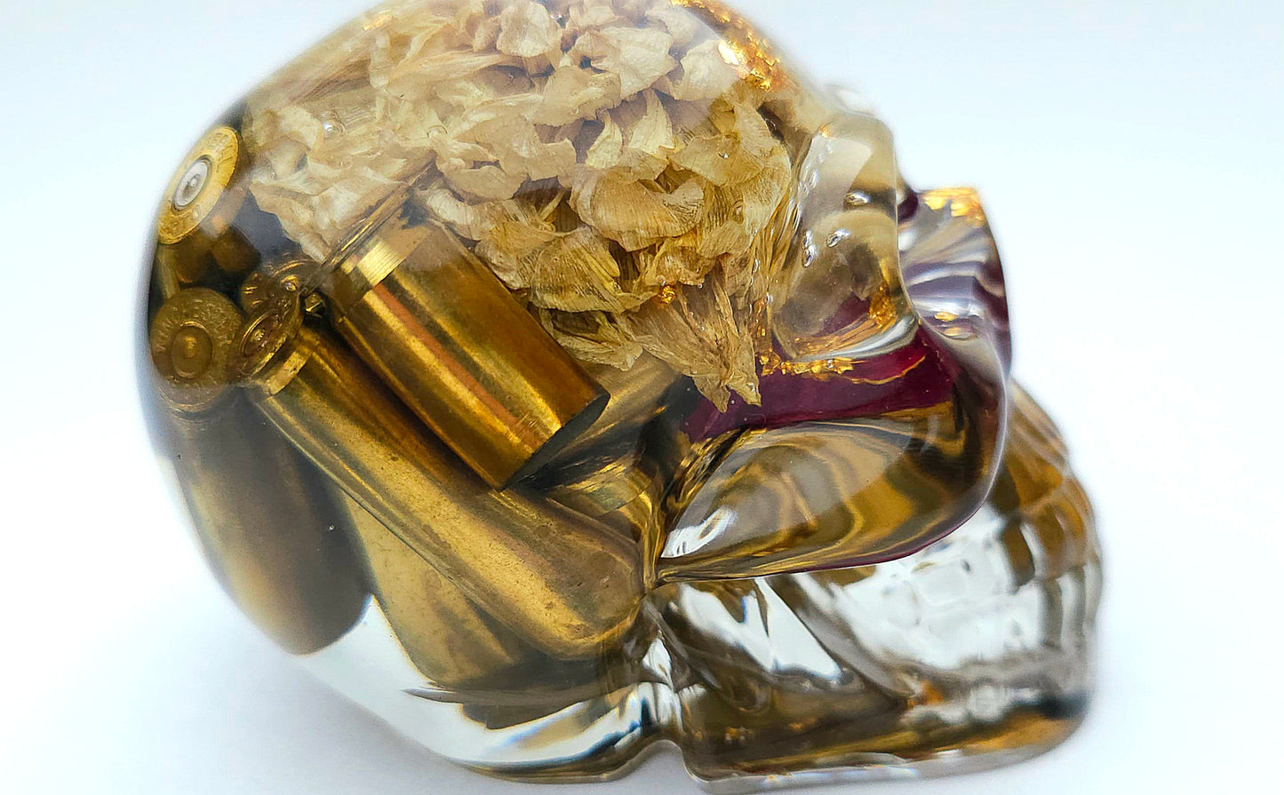 SOLD*Handmade Resin Skull- With wild dried Hydrangea flower mixture.  We've also added spent brass shells to help ground the piece some contrast.