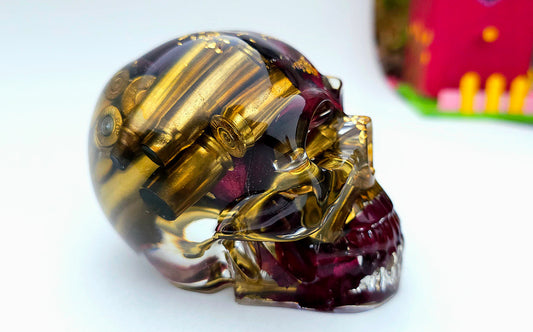 *SOLD*Handmade Resin Skull - With brass shell casings, wild Rose and purple flowers, plus gold accents.