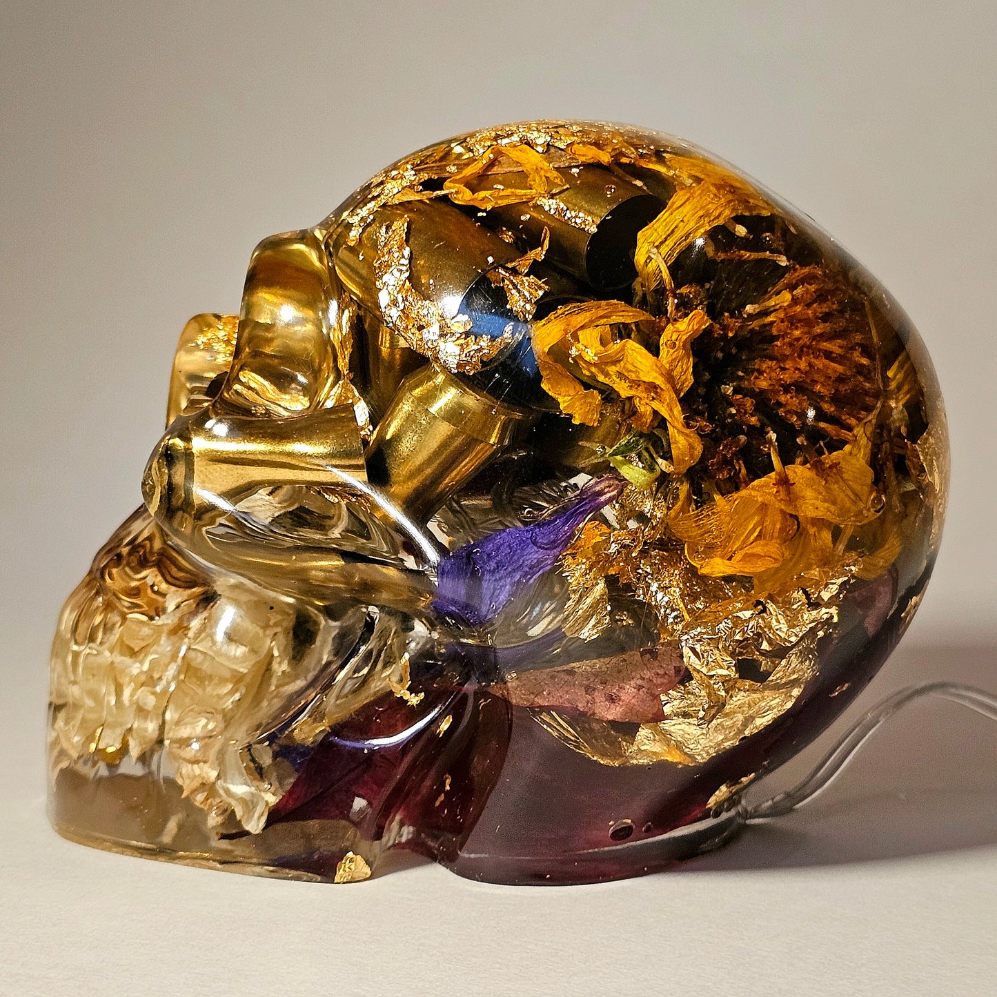 #0268 Handmade Resin Skull - Mixed flowers and brass in clear resin. HAS LIGHTS. Battery operated.