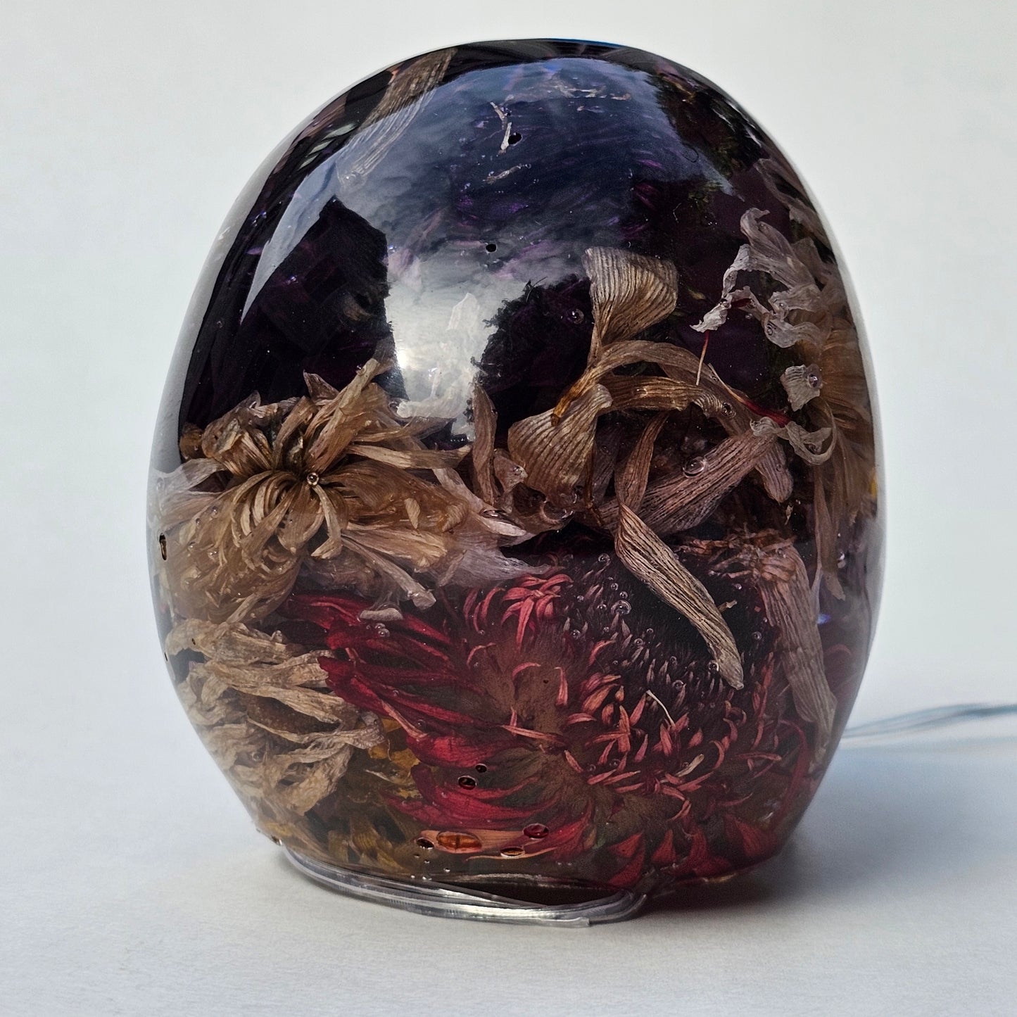 #0293- Handmade Resin Skull - Autumn flower blend in light purple resin. This one lights up! HAS LIGHTS!