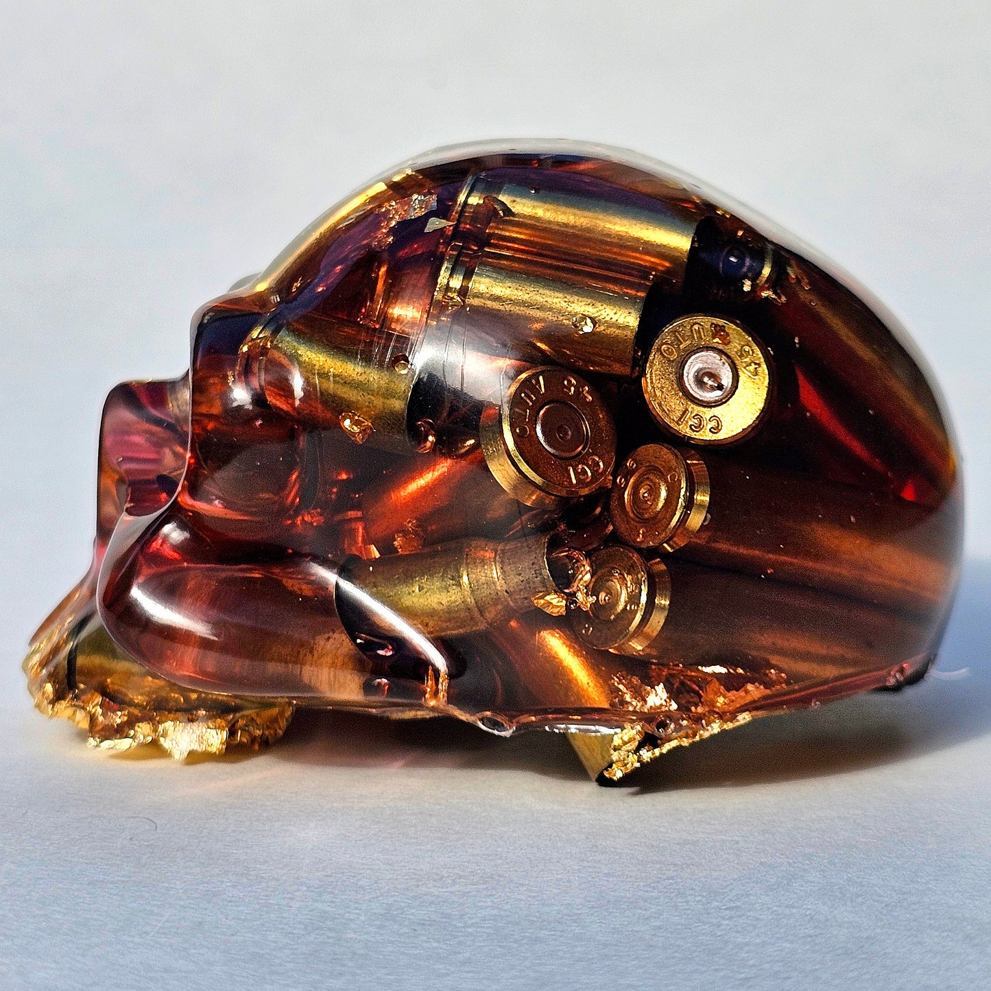SOLD#0287 - Handmade Resin Skull -    We call it the "Halfer". Fun piece, in red resin with brass hanging out the bottom. Gold accents.
